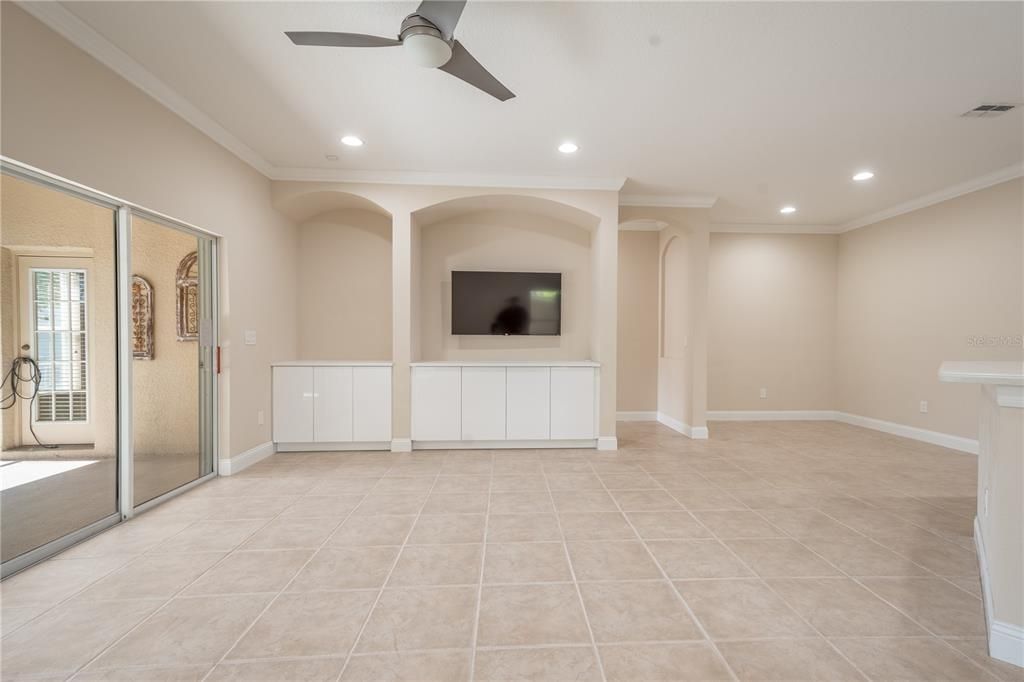 The Family room features ceramic tile flooring and a ceiling fan with light kit.