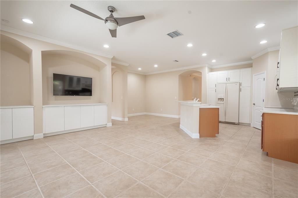 The family room features architectural detail, built-in cabinets and a neutral color palette.