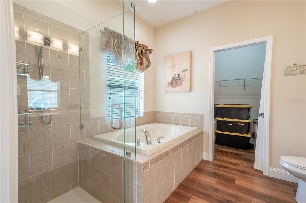 The primary bath features wood laminate flooring