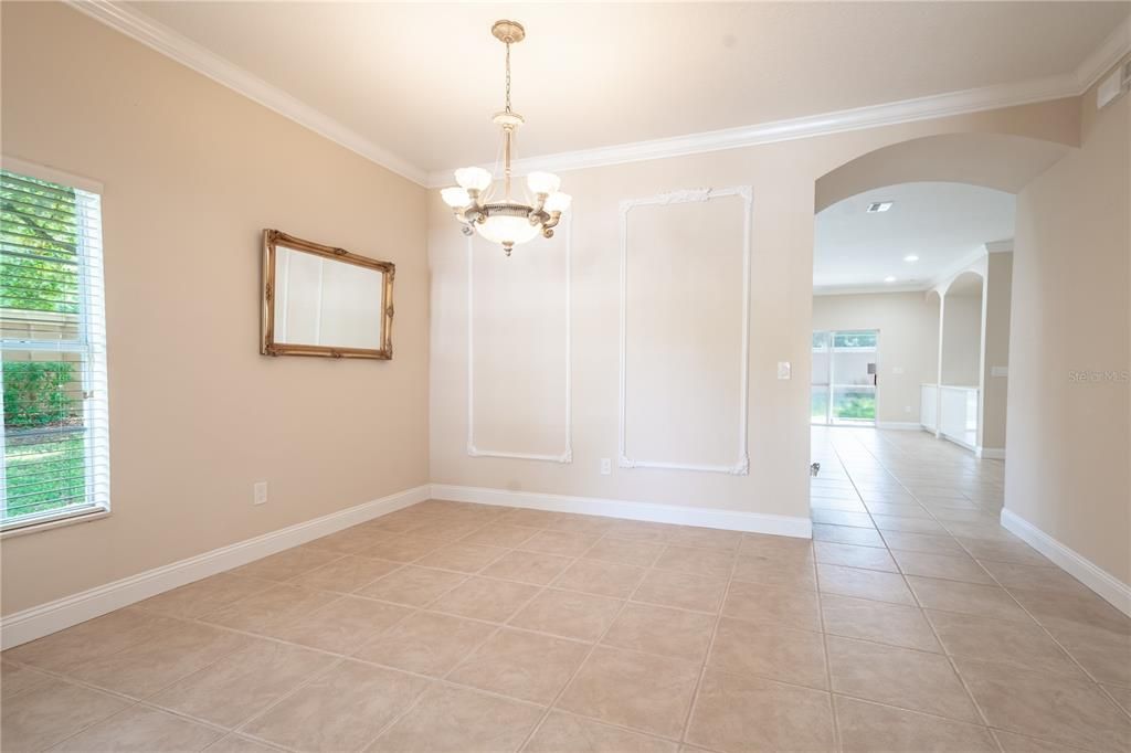 The Dining room features an arched entry and neutral color palette