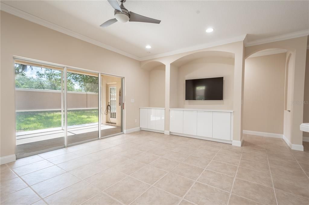 The family room features sliding glass doors to the screened in lanai.