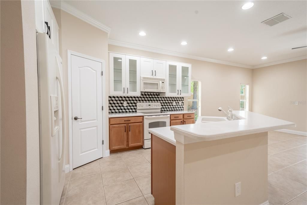 The Kitchen features ceramic tile flooring and recessed lighting.