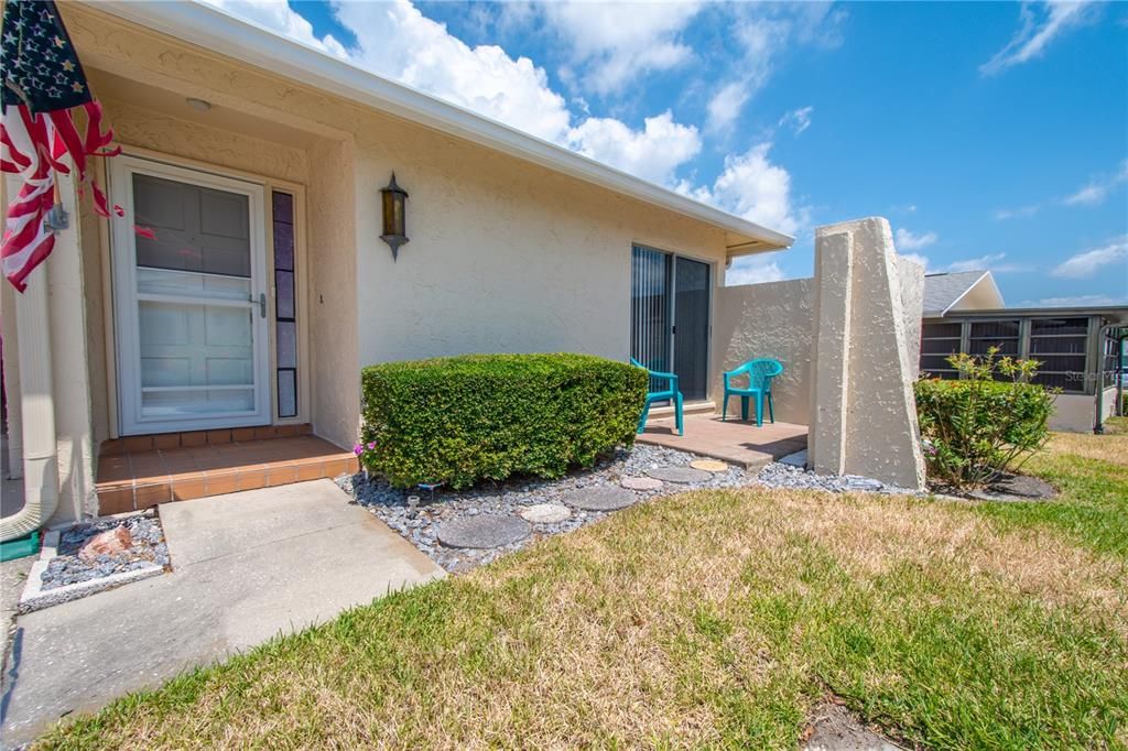 Walkway leads to covered entry at front door.