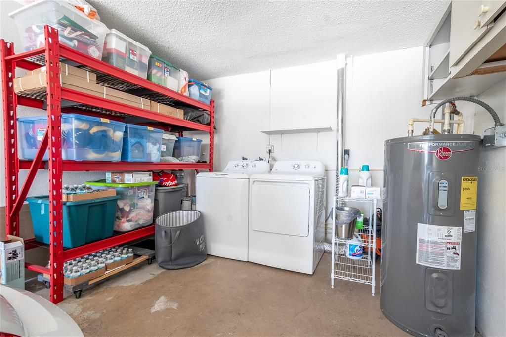 The garage features a washer and dryer as well as shelving for additional storage.