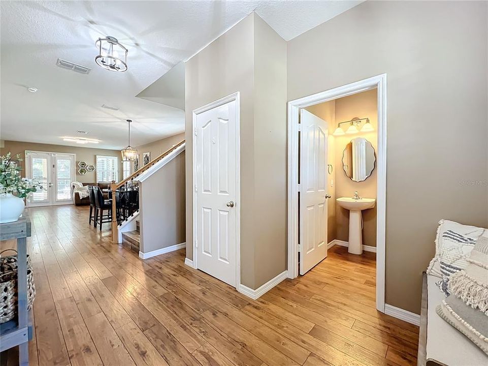 Front entry with under stairs storage closet and powder room