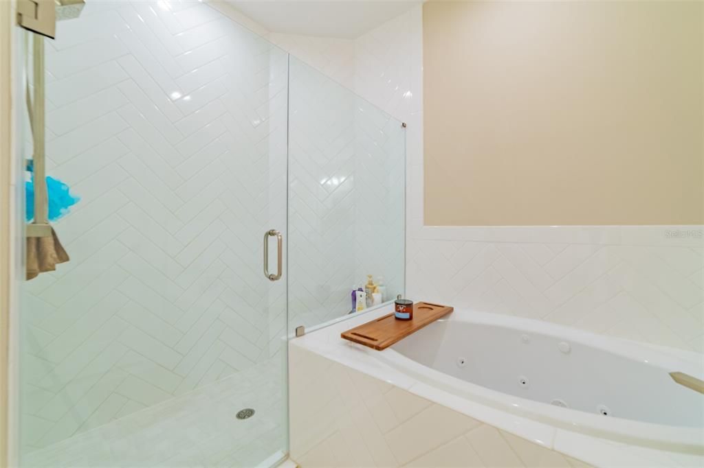 Walk-in shower with herringbone tile walls