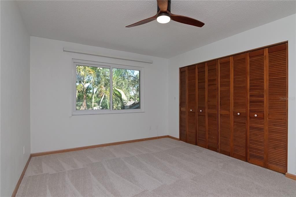 View of stairs from Formal Dining Room showing New Paint, New Carpet on Stairs, New Vinyl Under Stair and in Living Room and Tile Flooring