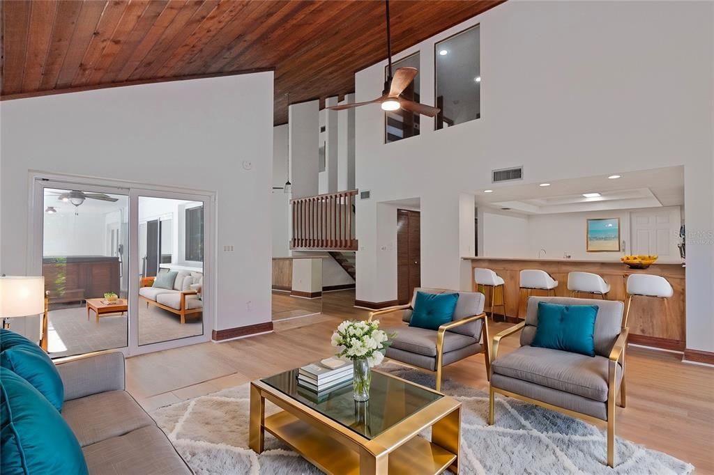 Family Room with Wood-Burning Fireplace, New Paint, New Vinyl Floors, Ceiling Fan and Hurricane-Rated Windows