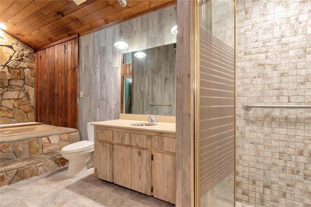 Primary Bathroom view from Garden Tub with Entrance to Shower, Linen Closet, Sink and Vanity with Quartz Countertops and Tile Floor