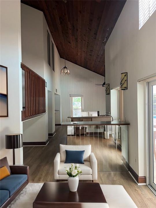 Family Room with Wood-Burning Fireplace, New Paint, New Vinyl Floors, Hurricane-Rated Windows and Hurricane-Rated Slider leading to Pool