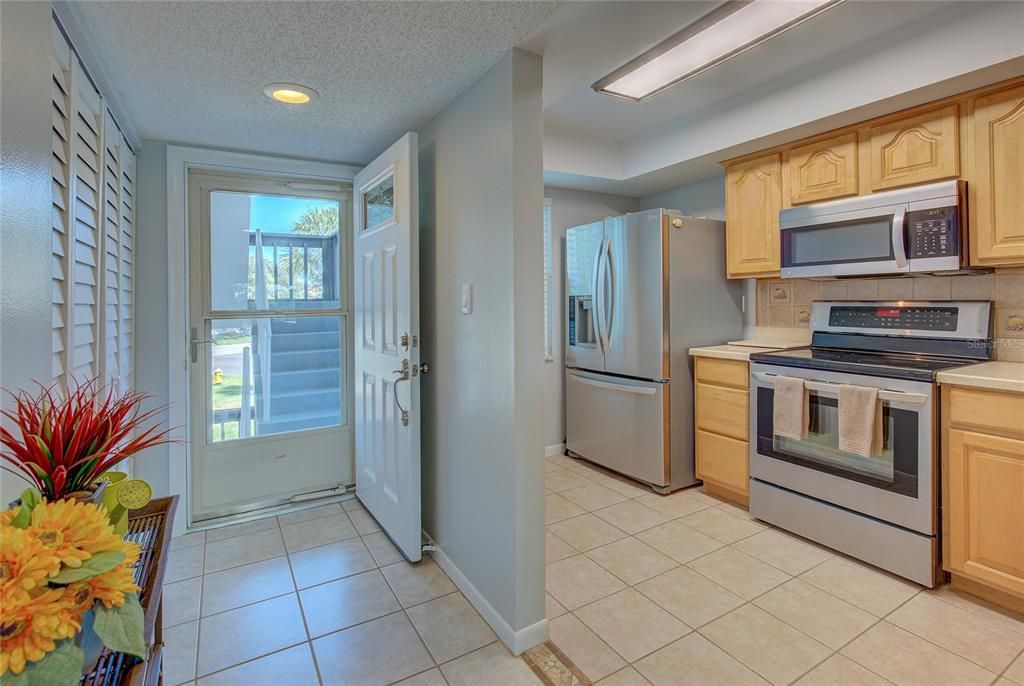 Front door and kitchen. Laundry closet on the right as you enter unit.