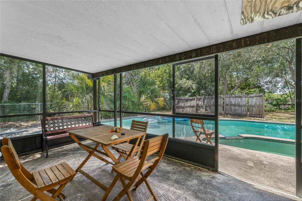 Screen porch leading out to pool area