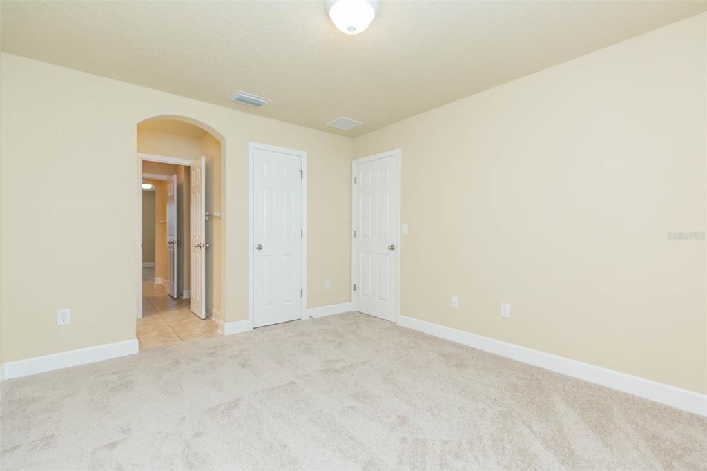 bedroom upstairs with walk in closet and access to jack and jill bath