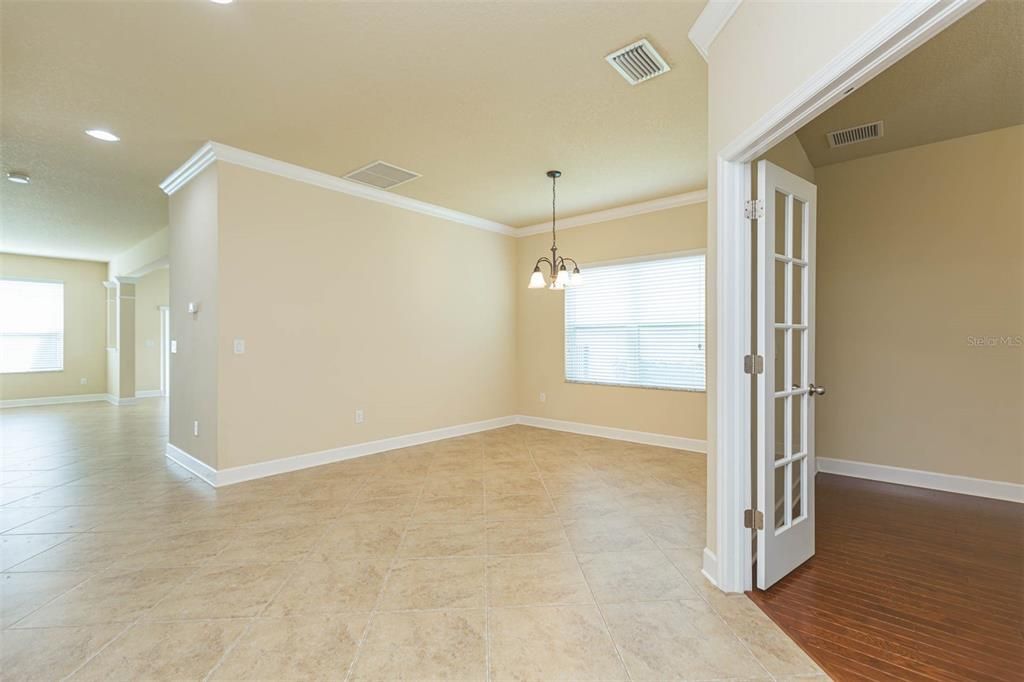 front foyer with formal dining room and office on your right