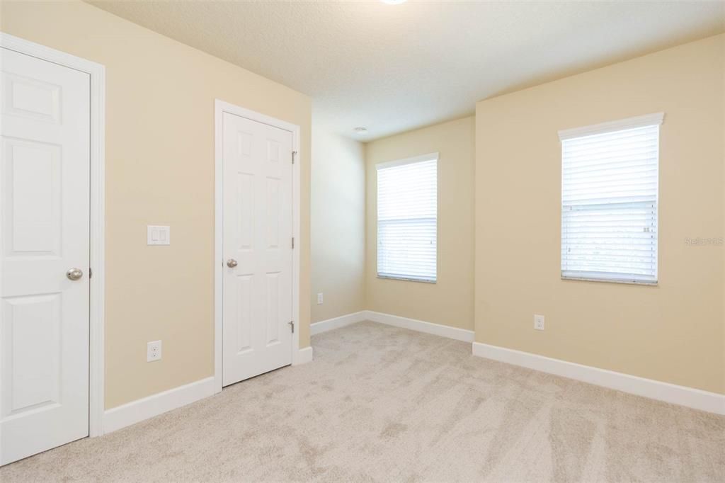 bedroom #3 upstairs with walk in closet