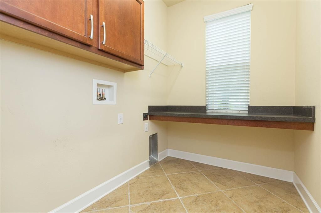 laundry room with built in cabinets