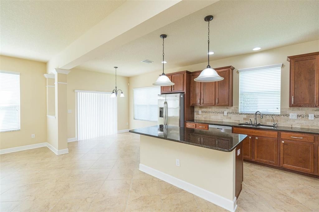 spacious kitchen with view of breakfast nook and patio access