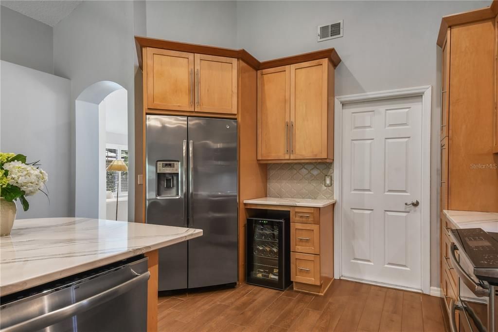 View of the new wine refrigerator. Door to the living/dining rooms to the left, door to garage on right.