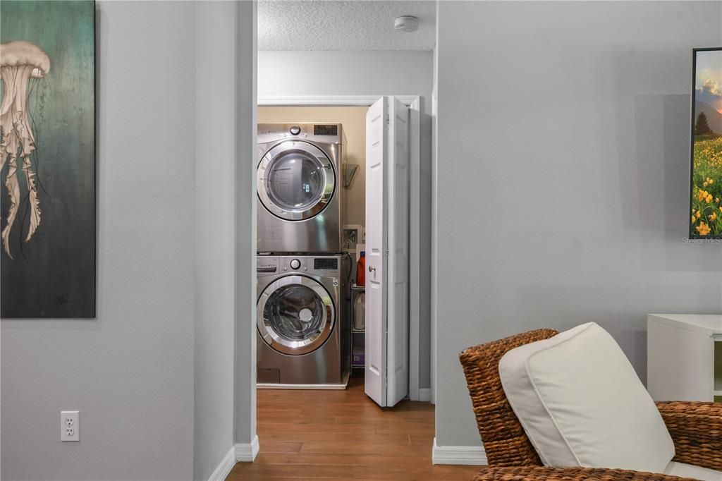 Laundry closet in the hall with new washer and dryer.