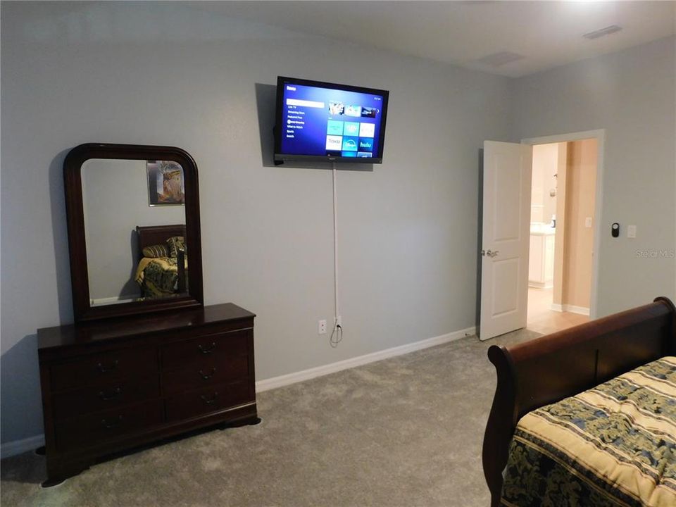 Primary Bedroom with TV and Chest of Drawers