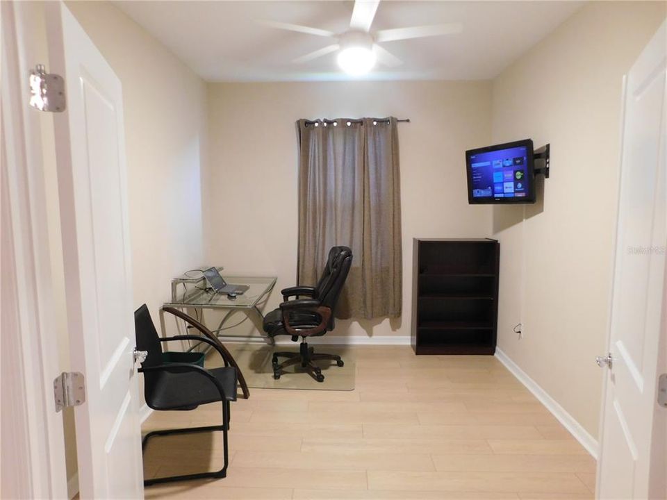 Office with Double doors, Desk, Book case, Guest chair and TV