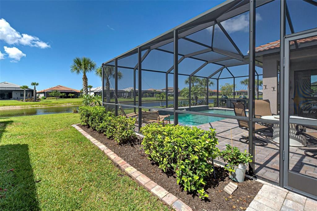 Extended lanai and pool from the side, exterior view.