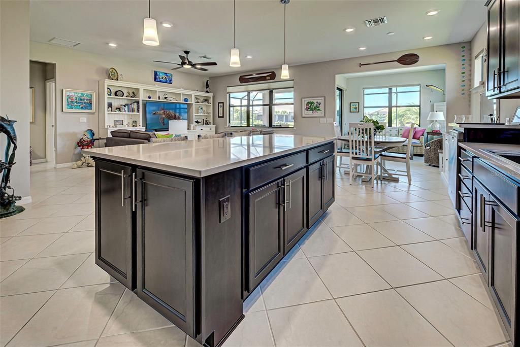 Kitchen, gathering room, dining area and sunroom.