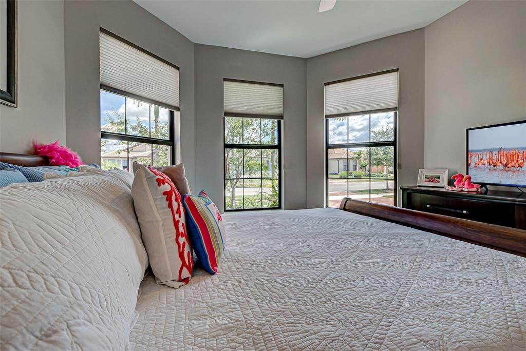 Guest room with angled front wall and custom blinds.