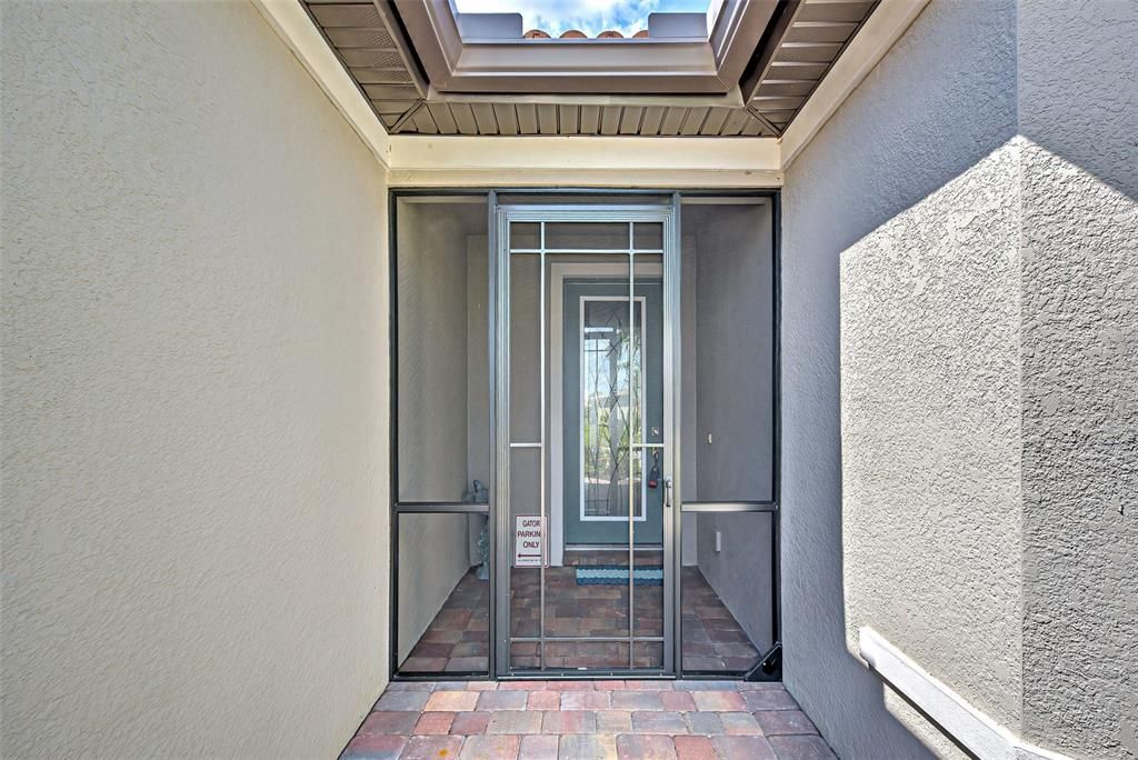 Screened in front entrance and impact glass front door.