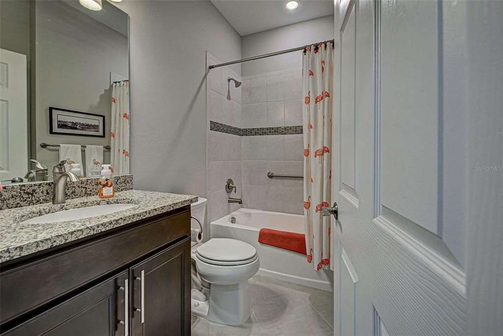 Guest bathroom with upgraded tile in tub area.