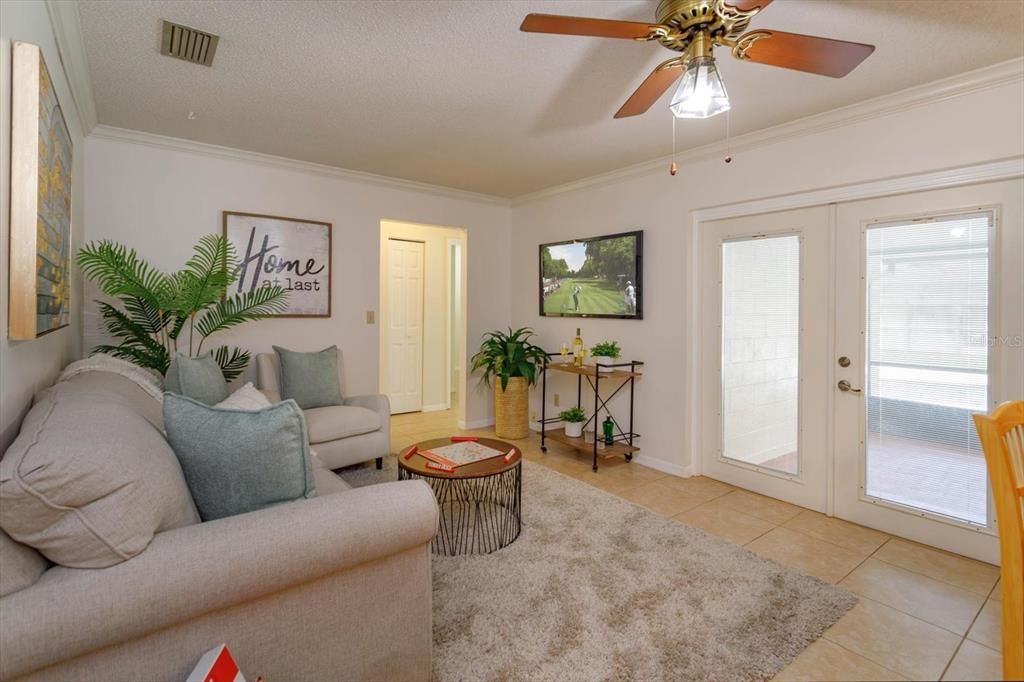 French doors open to back screened porch and pool