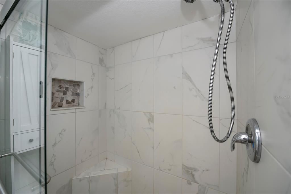 Large tiled shower with built-in seat
