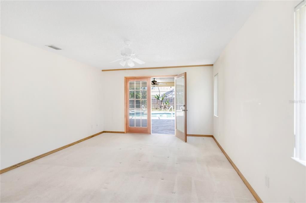 Primary Bedroom French DDoors to LAnai and Pool