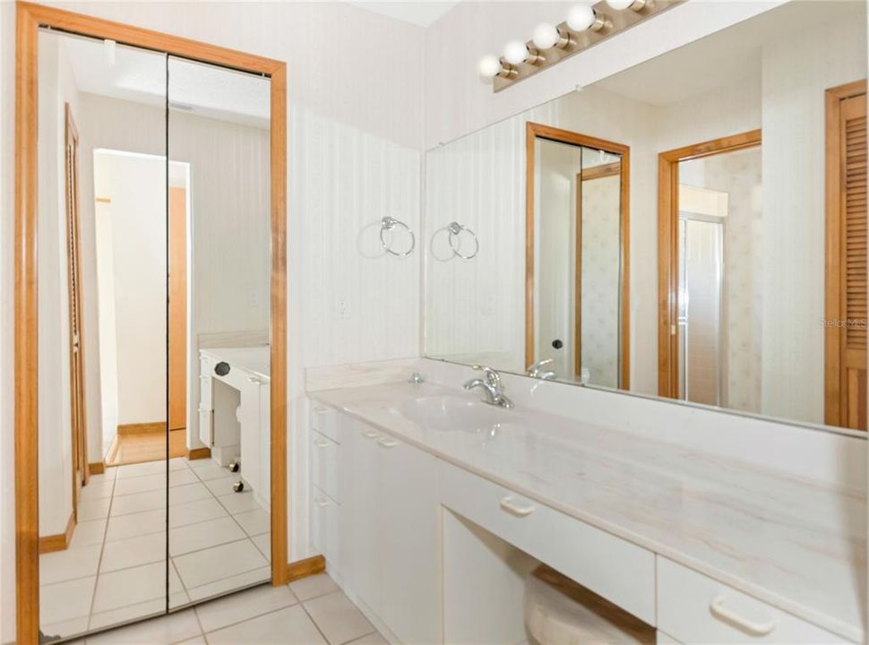 Primary Bathroom has Twin Vanity/Dressing areas with two walk in closets