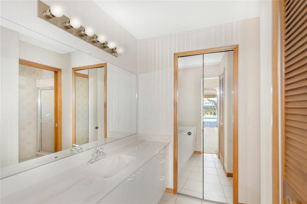 Primary Bathroom has Twin Vanity/Dressing areas with two linen closets