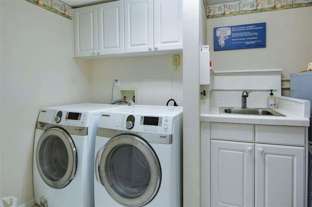 Good size Laundry area with a Sink, cabinets. Water Softner!