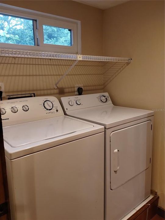 Laundry room has storage and is next to the kitchen.