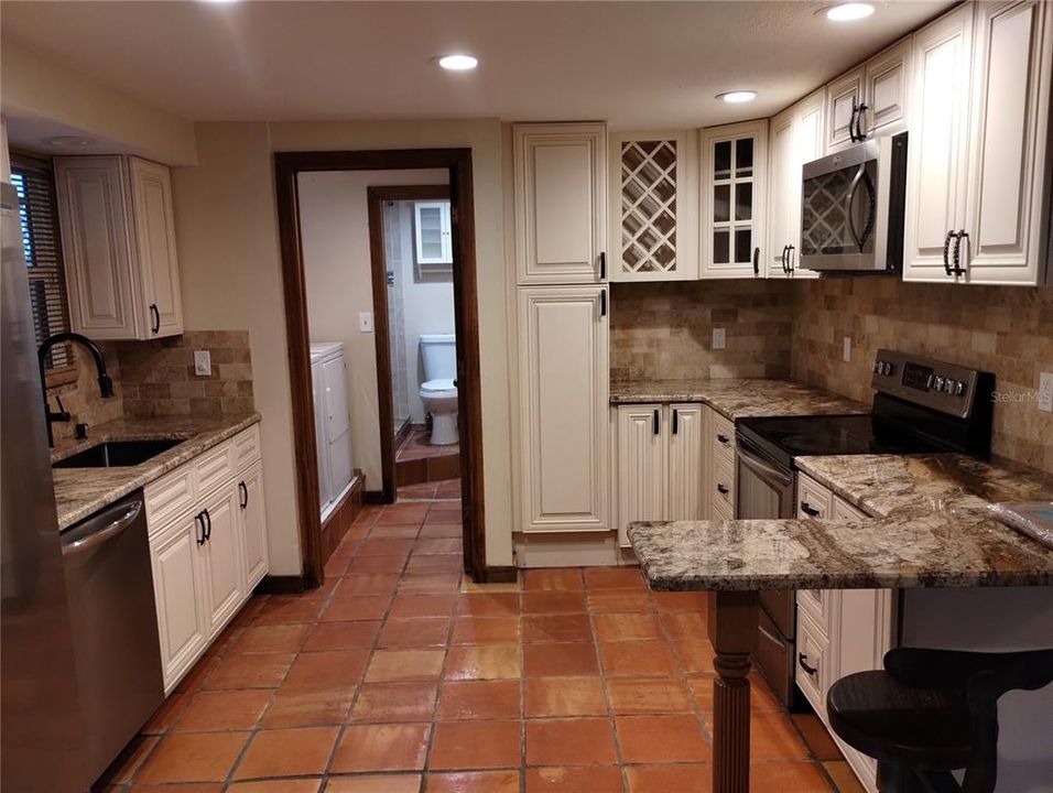 Kitchen has a pantry AND wine rack with a small breakfast bar for two!