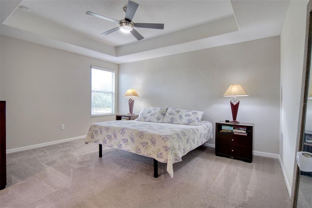 Welcome to your tranquil Master Bedroom Oasis featuring a tray ceiling.