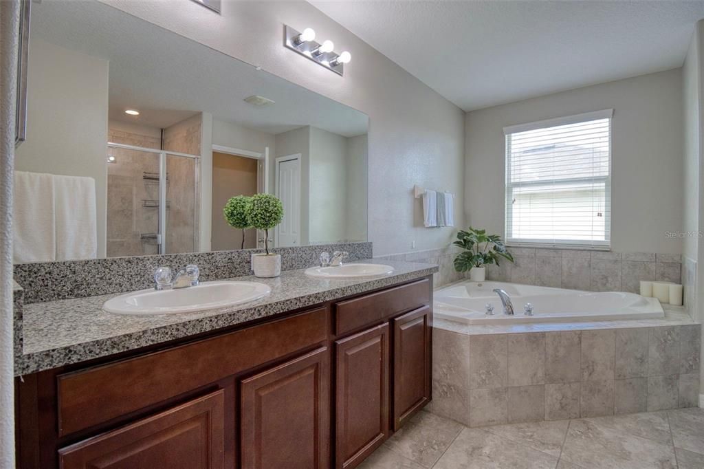 Master ensuite boast a grand double vanity featuring ample counter space, while the dual sinks offer convenience.