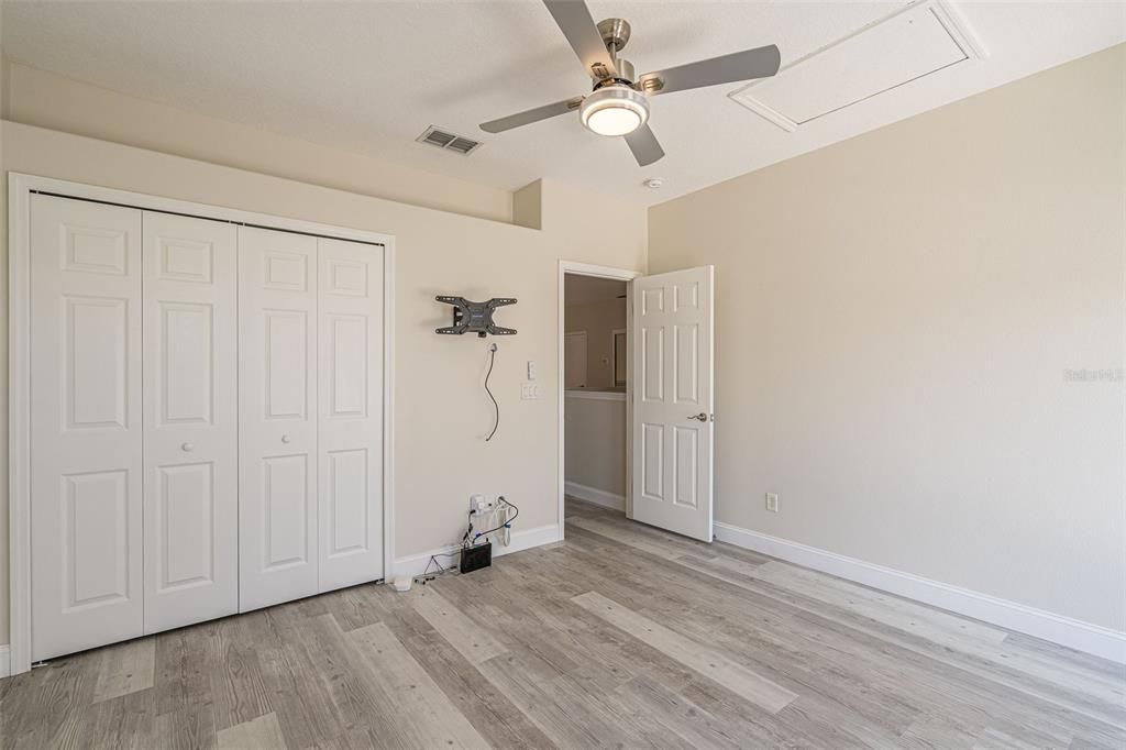 Upstairs bedroom with ceiling fan