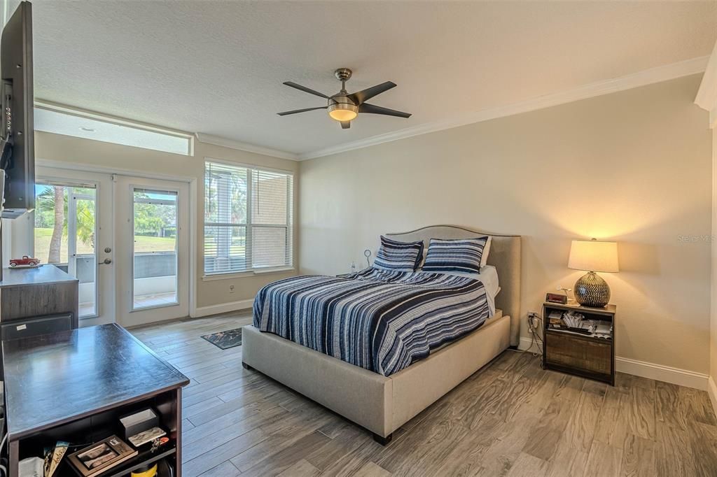 Main Floor - Primary Bedroom with French Doors overlooking the golf course