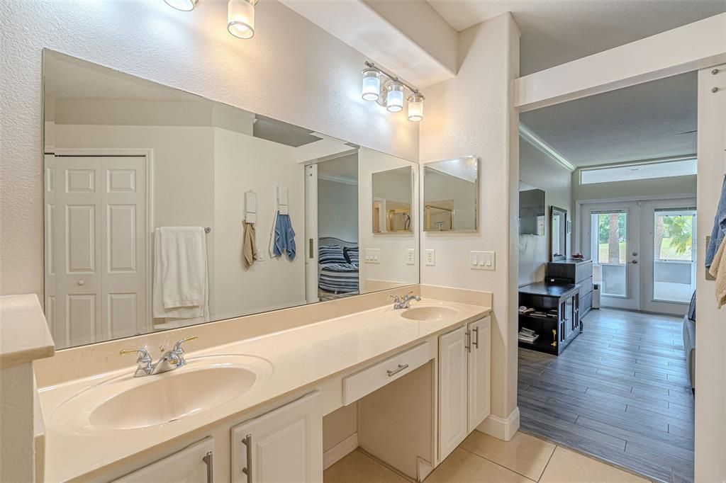 Main Floor - Primary Bathroom with double vanities and cultured marble.