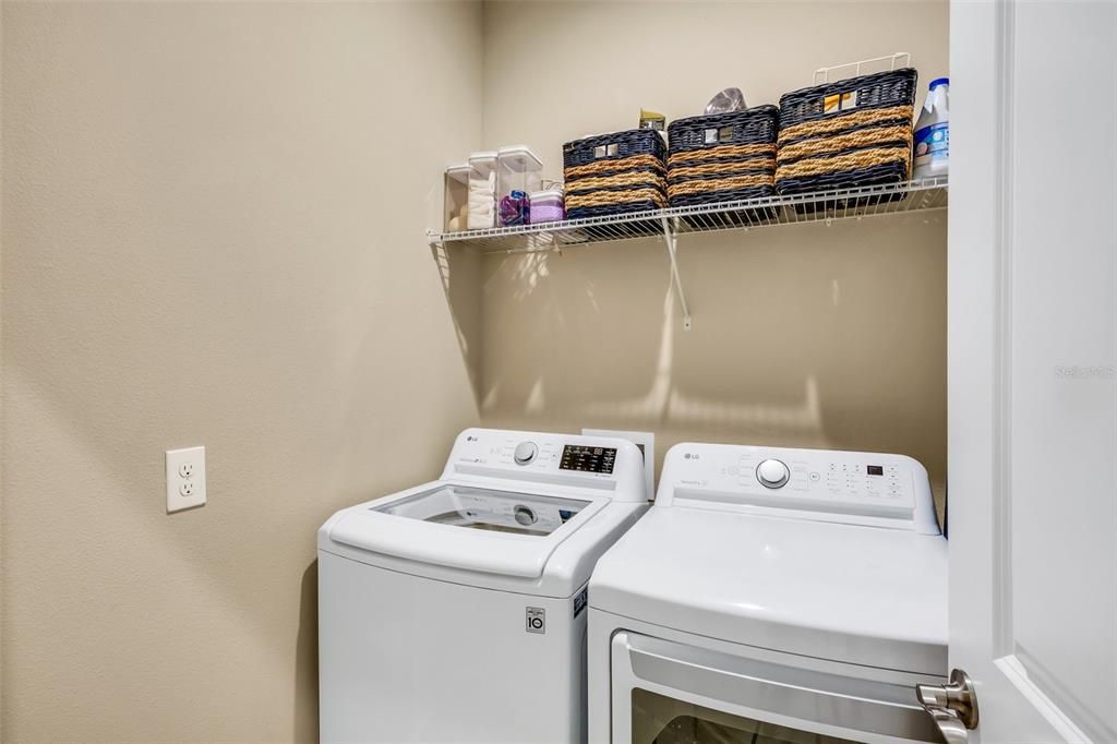 Laundry room located on the 1st level next to half bathroom
