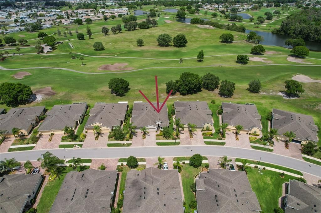 Greenbelt vista with custom paved driveway and vistas of wide open space.