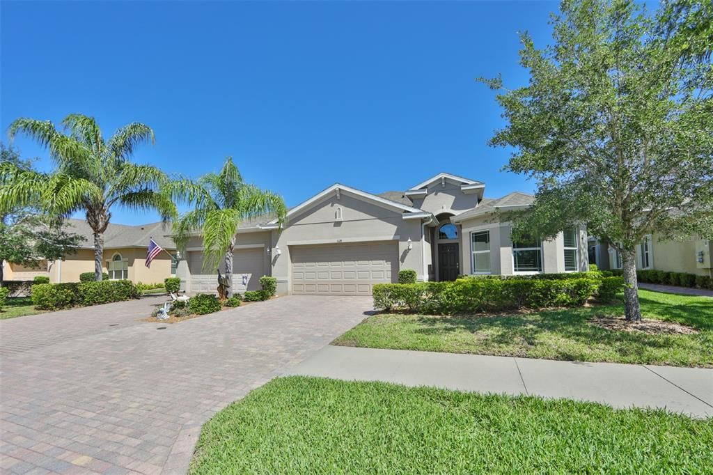 Manicured lawn and swaying palm trees make this a lovely and well managed gated community.