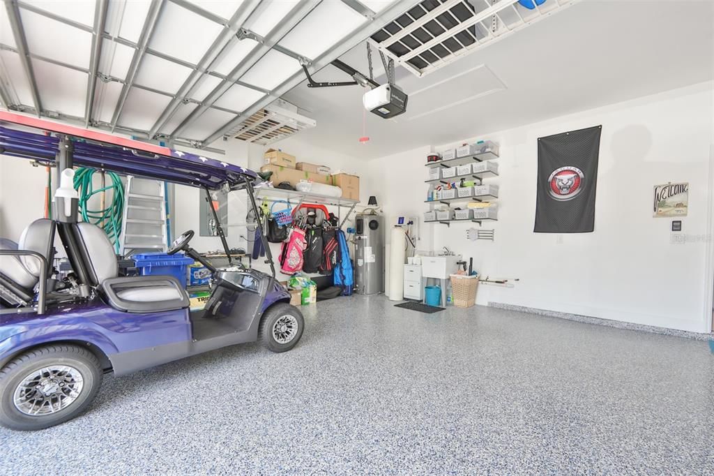 Notice the ceiling storage, wall storage, epoxy flooring, insulated garage door and high end water heater (which cools the garage, when water is heated).