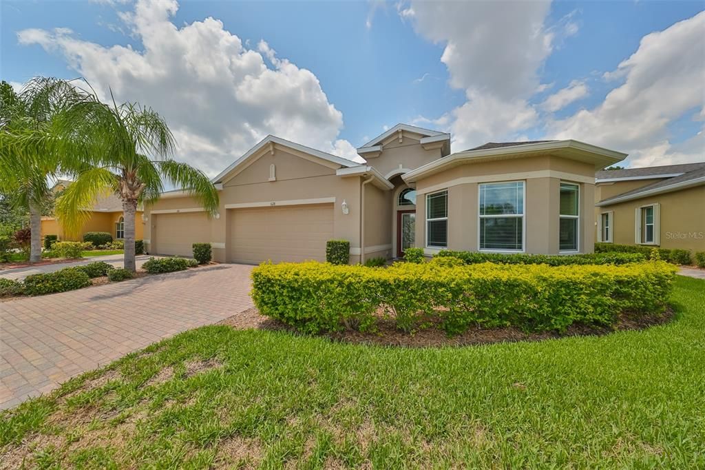 Handsome entryway, lovely pavered driveway and large exterior windows for sunshine, in the newest residential area of Sun City Center!