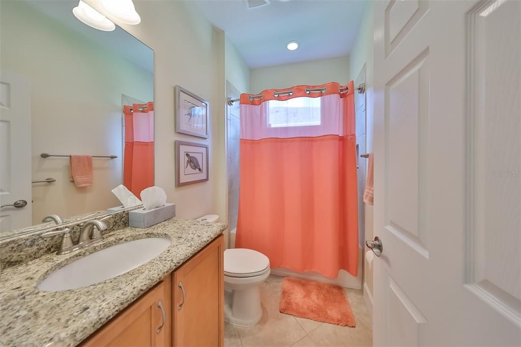 Guest bath is bright, sparkling clean and contemporary.