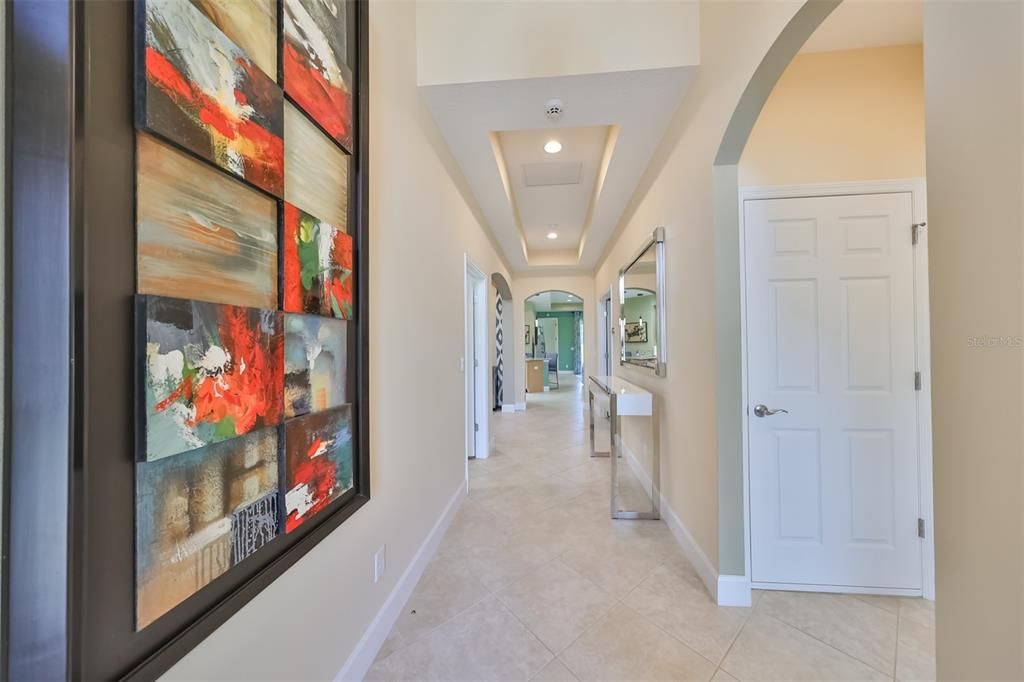 The entry way is bright, open and spacious with high ceilings and arched doorways.